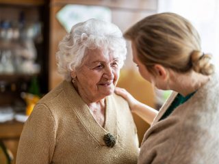 nurse talking to older woman