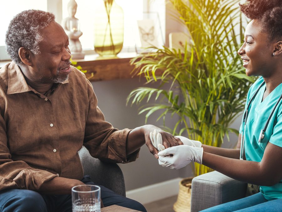 Older man receiving care from a nurse