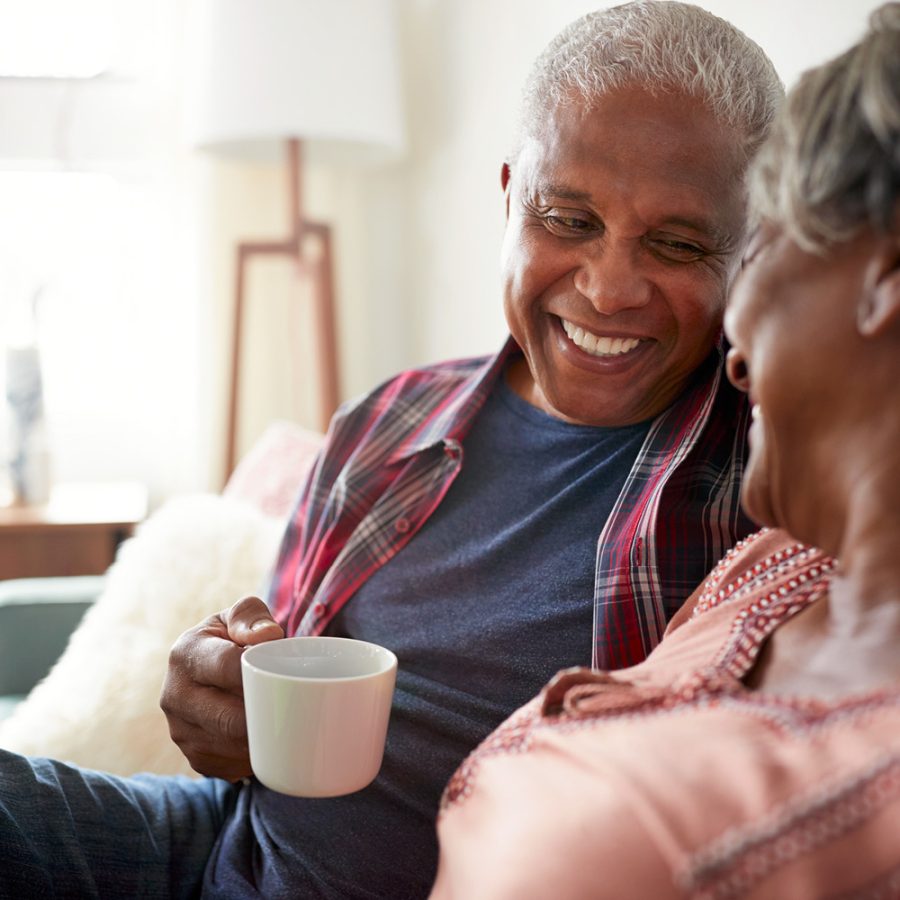 couple laughing and drinking coffee