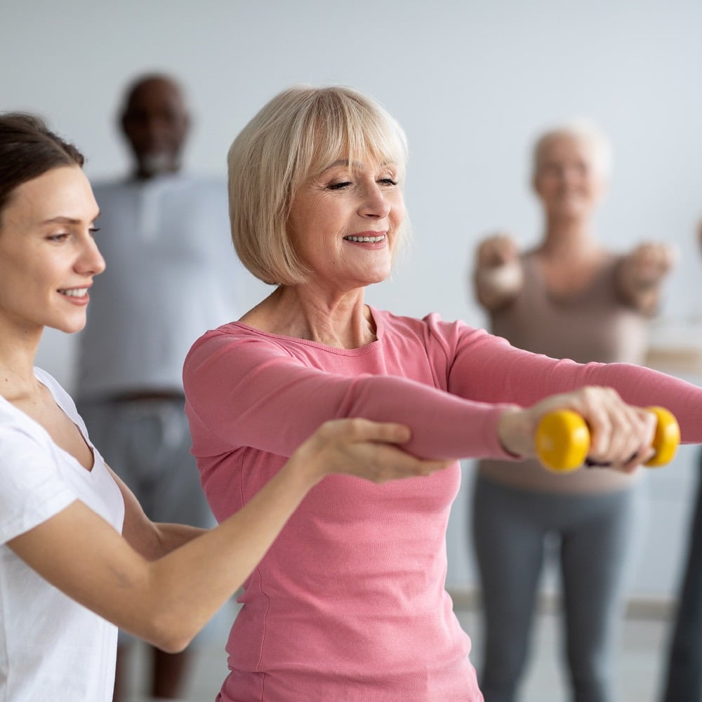 woman and trainer at exercise class