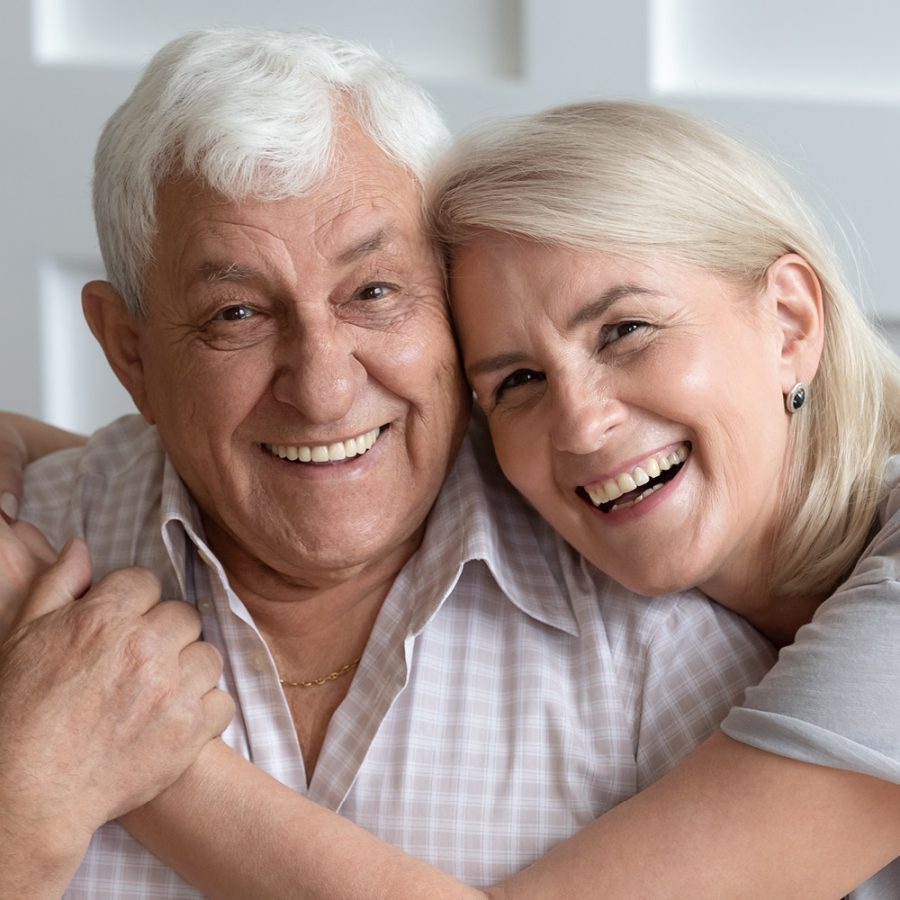 older couple holding each other and smiling