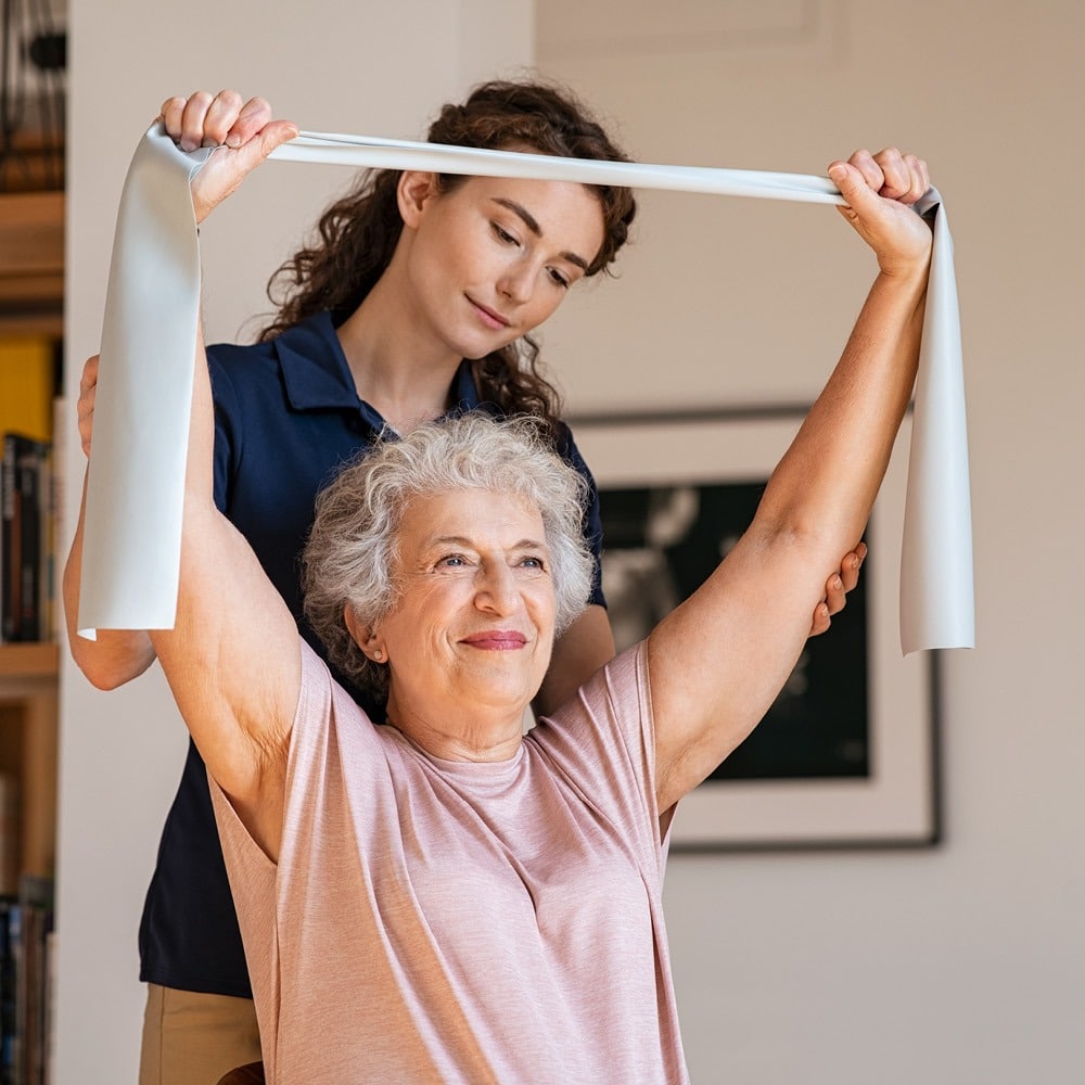 older woman doing physical therapy