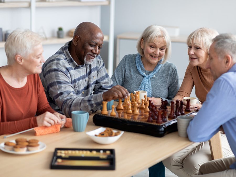 friends gathered around a chess board