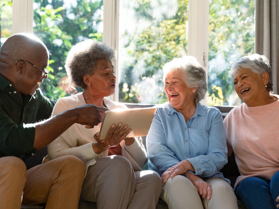 friends looking at a tablet and laughing