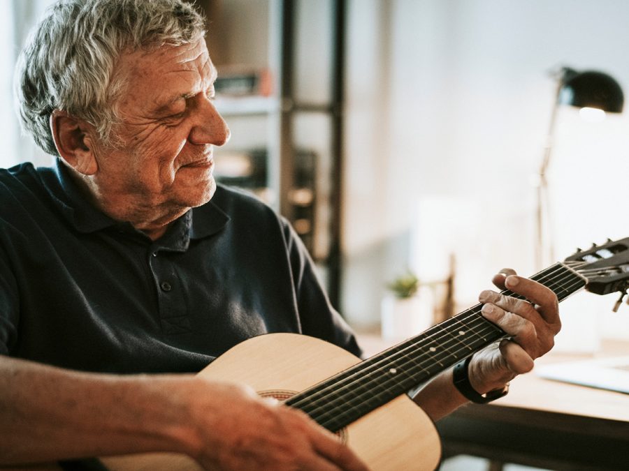 older man playing guitar