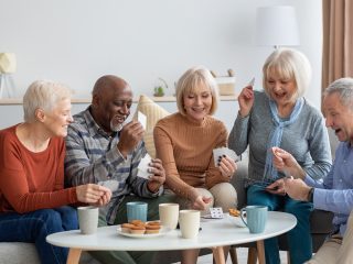 friends playing cards and having dessert