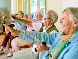 older women doing resistance band workout