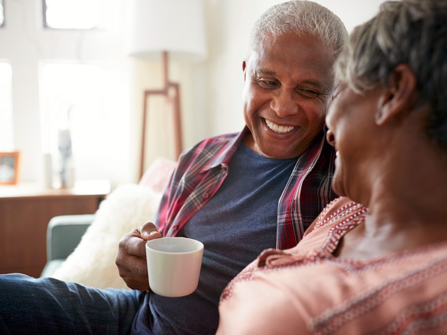 older couple laughing over coffee
