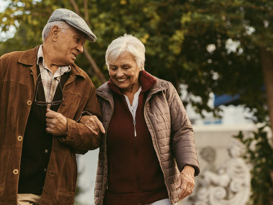 older couple walking arm in arm