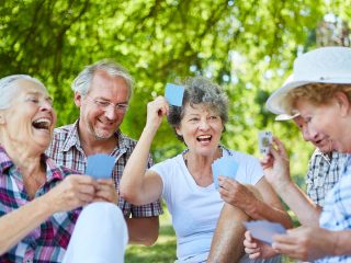 friends playing cards outside