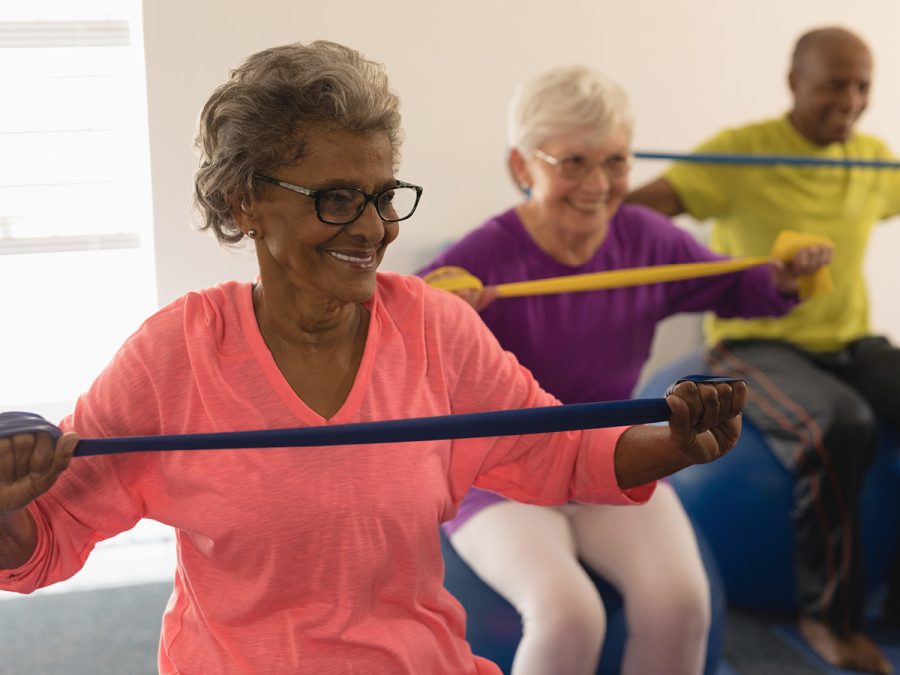 older people doing resistance band exercises