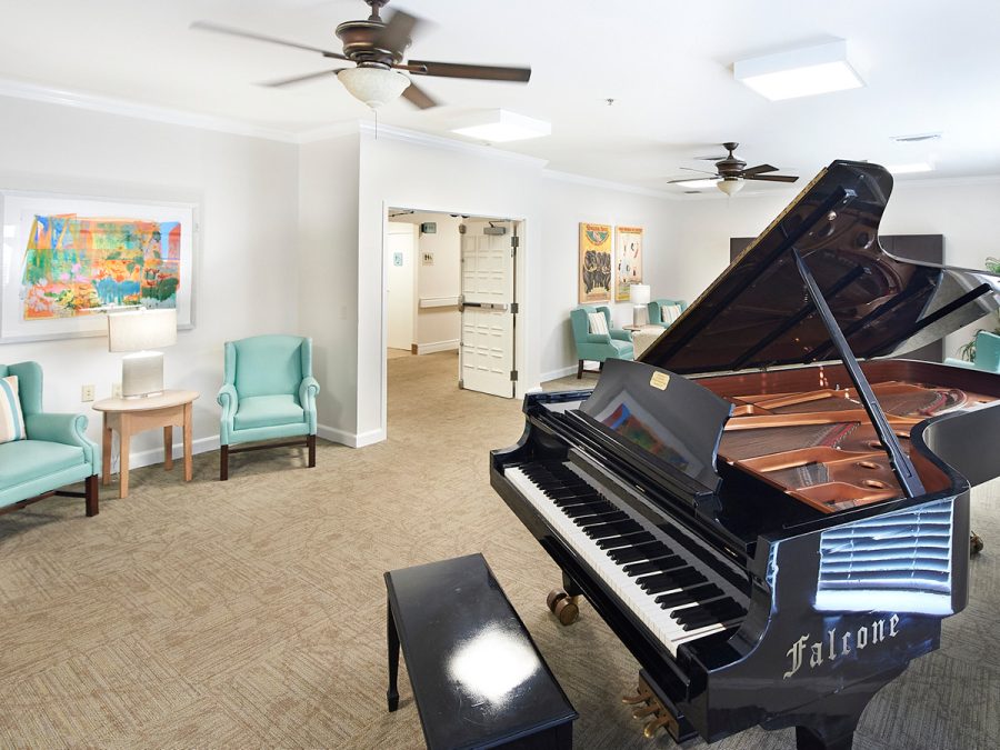 living area with grand piano and big screen tv