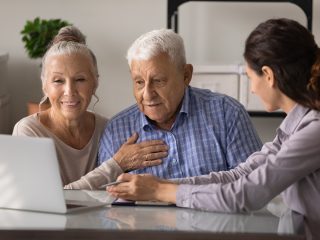 people talking in front of a laptop