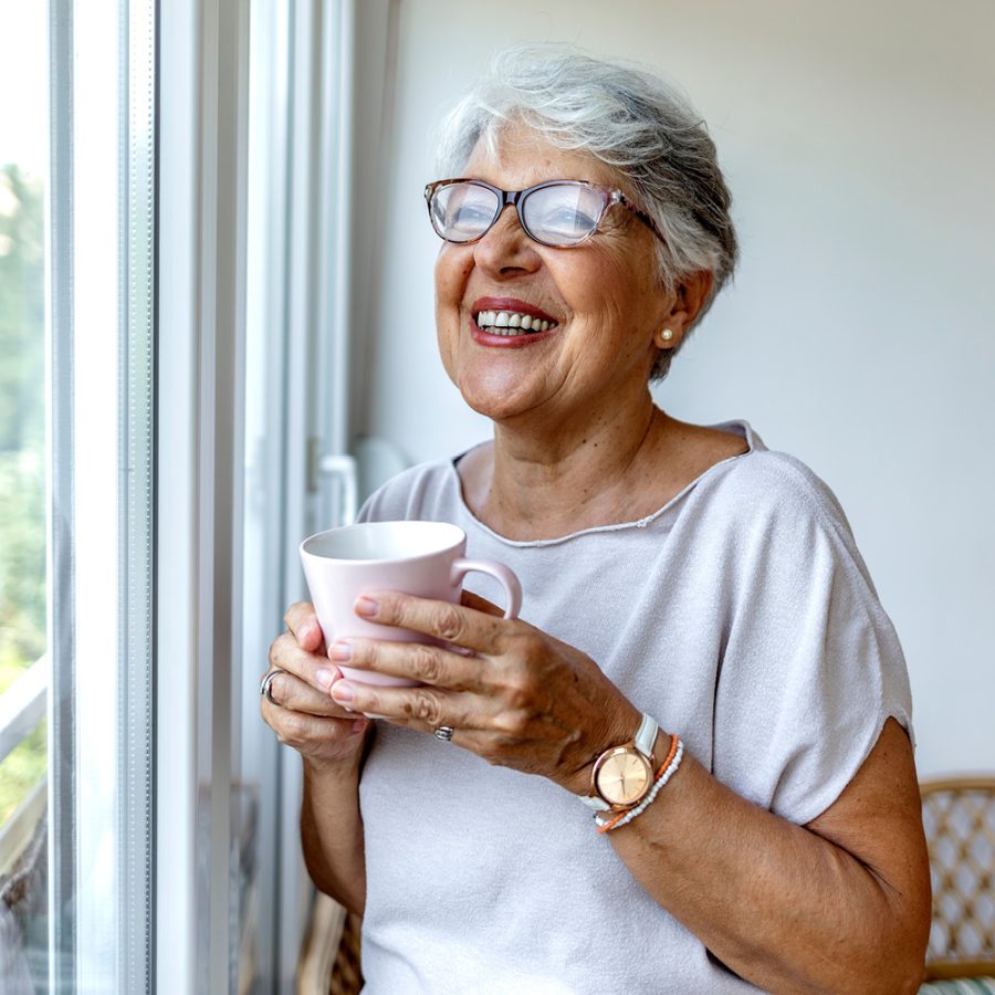 woman enjoying her coffee by the window