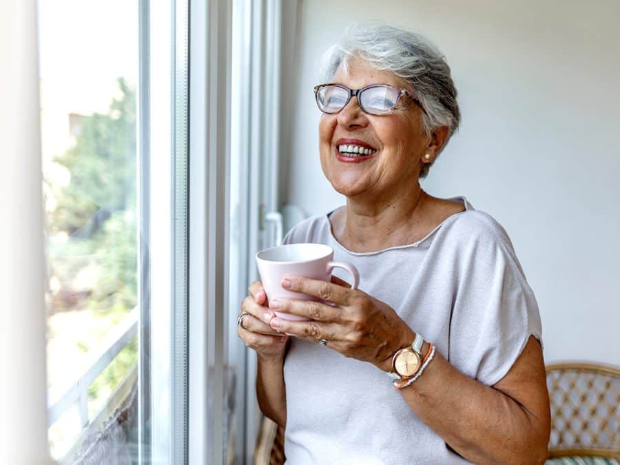 woman enjoying coffee by the window