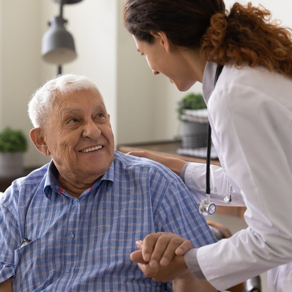 nurse assisting older man