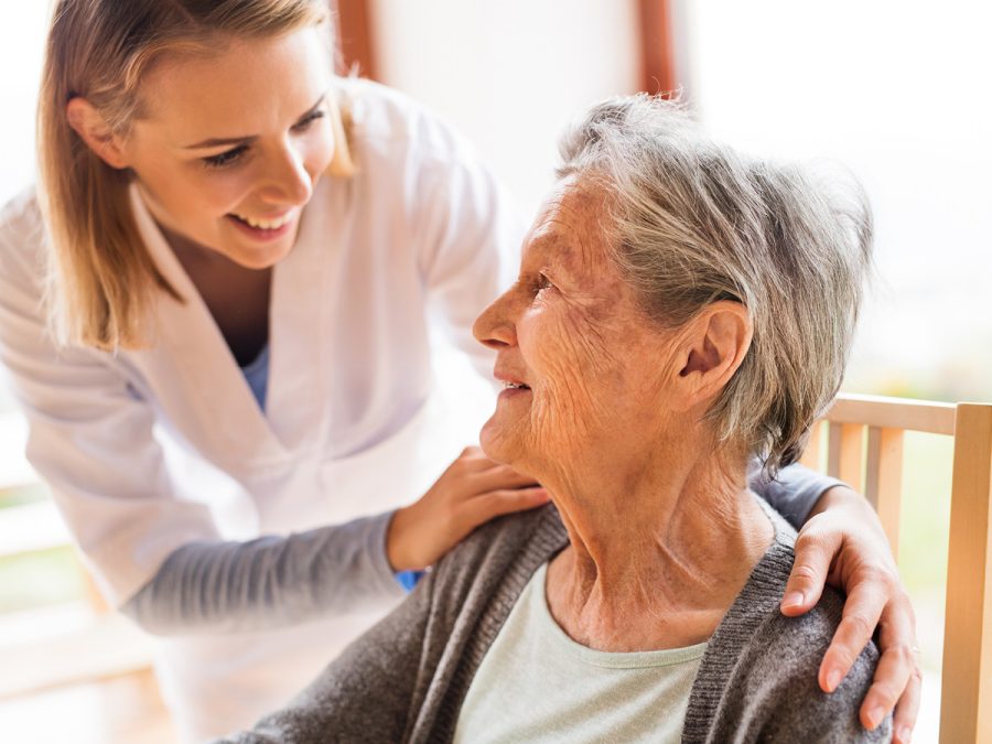 nurse talking to older woman