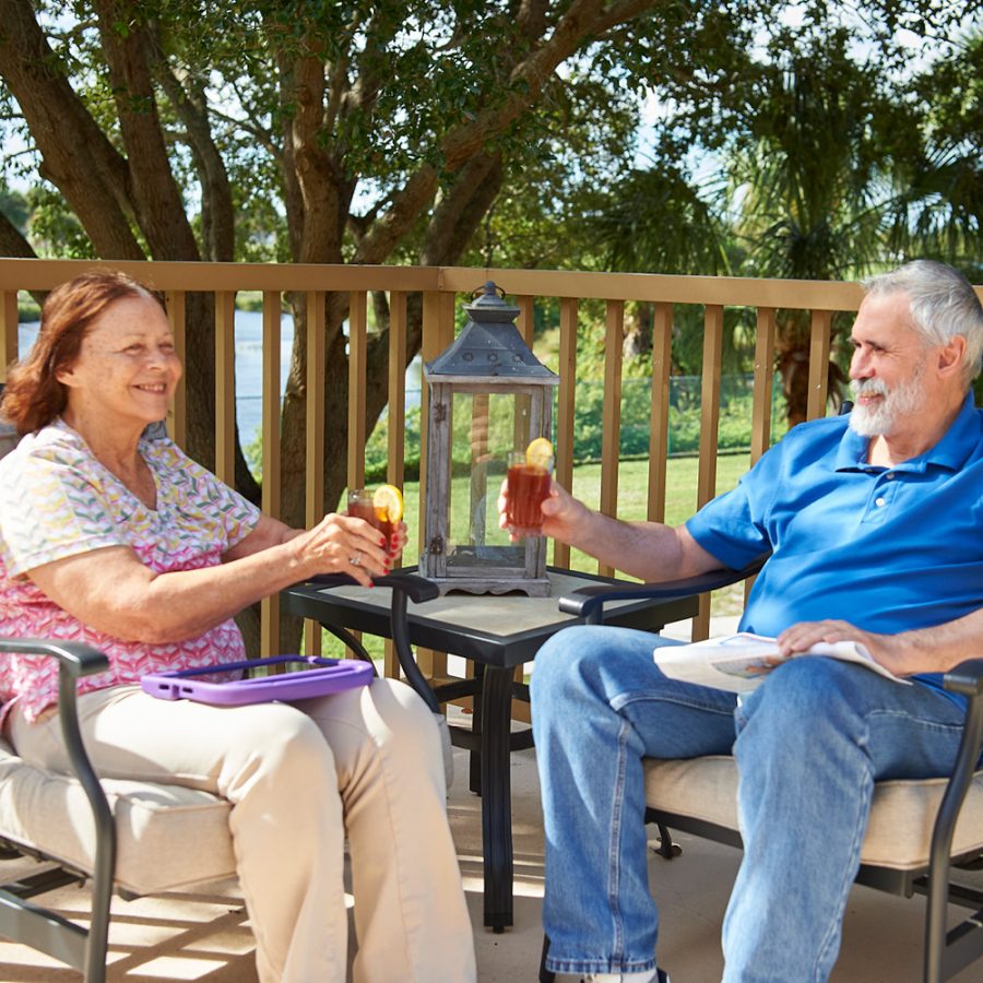 older couple enjoying drinks out on the deck