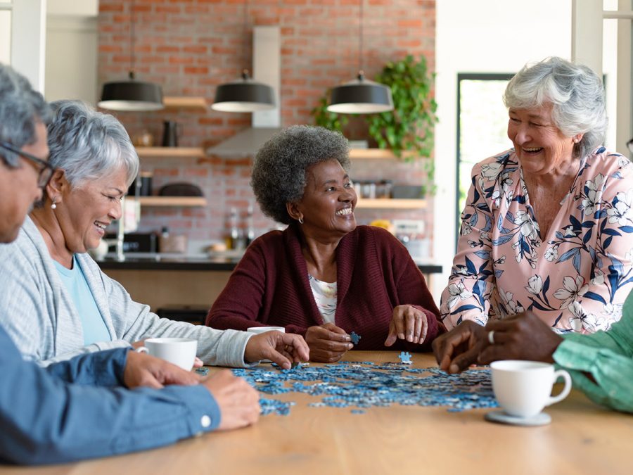 older friends putting together a puzzle