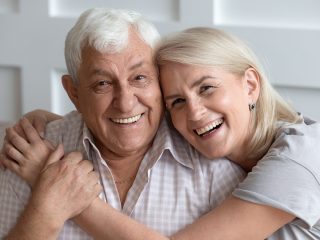 older couple holding each other and laughing