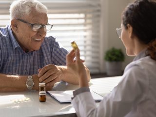 nurse explaining meds to older man