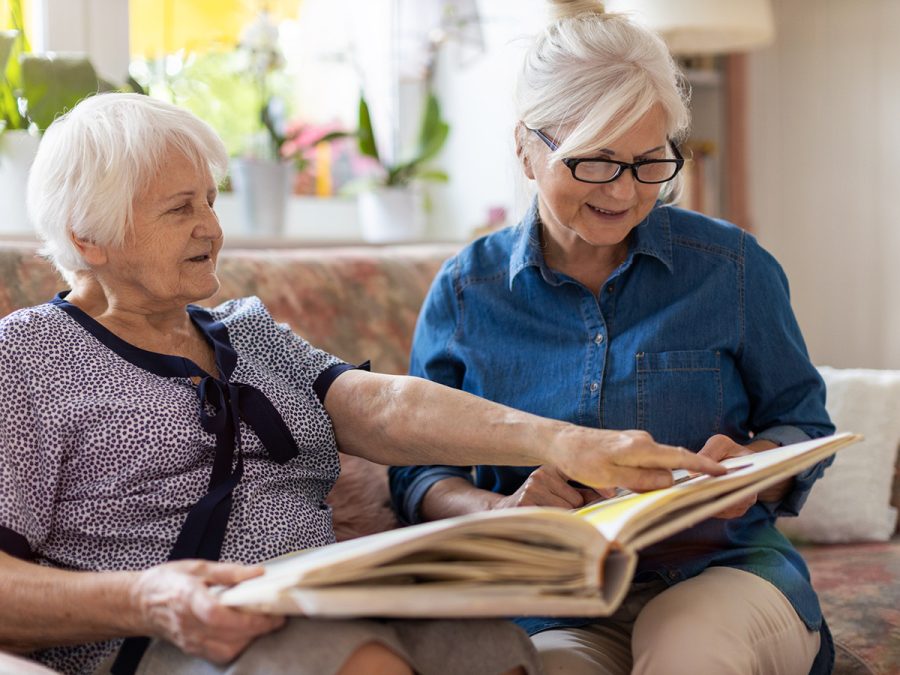 older women looking at a scrap book