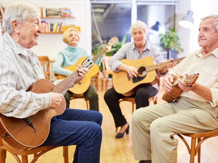 older people playing guitar