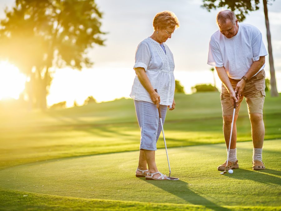 older couple golfing together