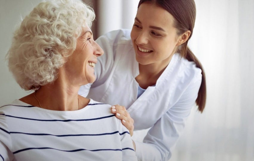 young nurse talking to older woman